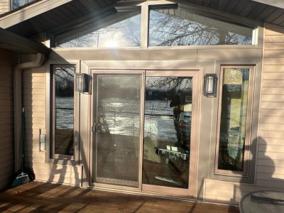 moline patio door replacement - outside view of new glass patio doors with two triangle windows above, after