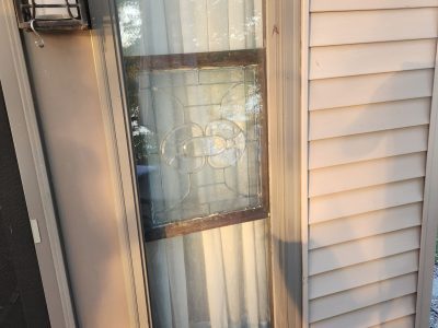 moline patio door replacement - outside view of long three-paned window, before