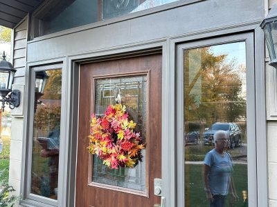 moline patio door replacement - outside view of old brown patio door with wreath, before