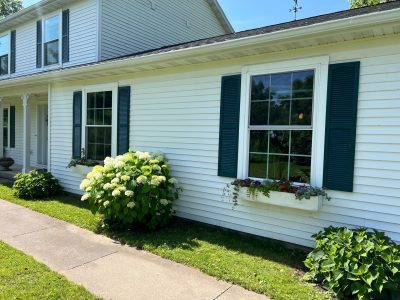 geneseo window installation - side view of white two-story house with new windows, after