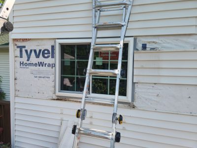 geneseo window installation - single window with ladder and construction materials, during