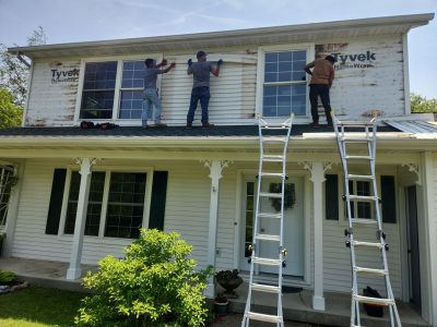 geneseo window installation - contractors with ladders installing new second-story windows, during