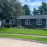 clinton siding installation - front street view of house with new navy siding, after