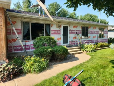clinton siding installation - front of house with siding construction layers, during