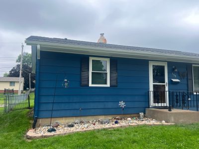 East Moline Window Installation - outside view Double-Hung window with shutters near front door, after