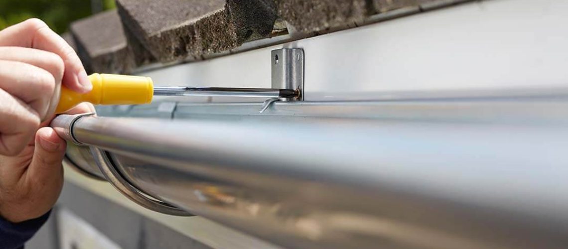 man installing gutter guards in illinois