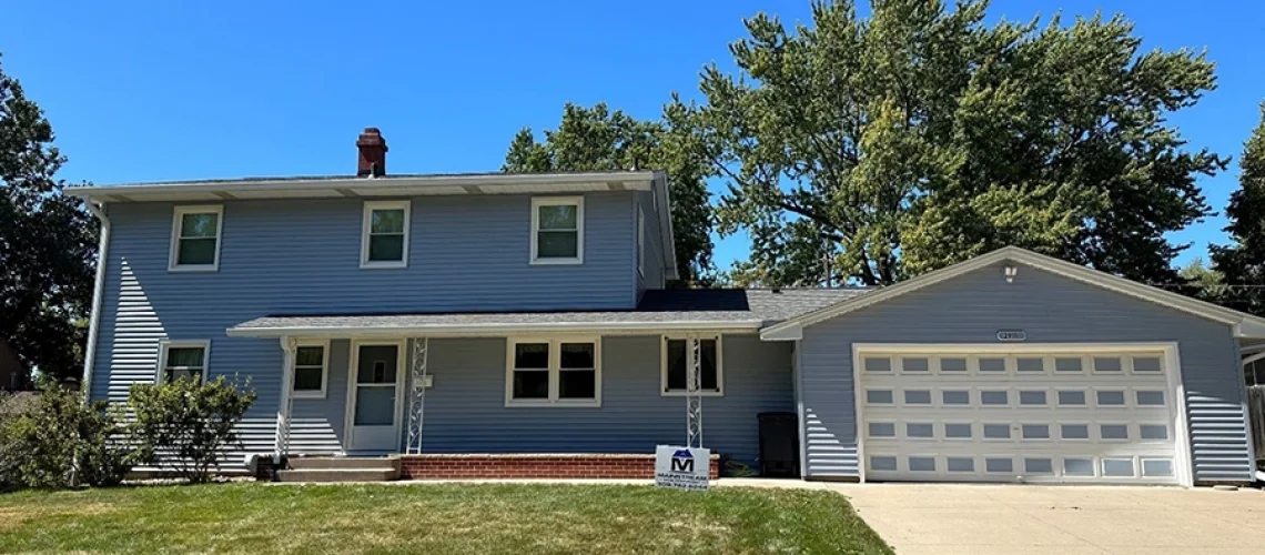 This is a photo of a house in Rock Island, IL with new siding, windows, and a roof installed by Mainstream Home Improvement.